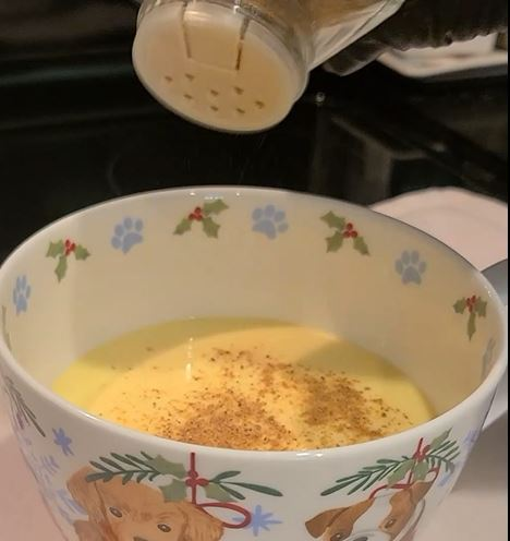 Glass of homemade egg nog with nutmeg on top